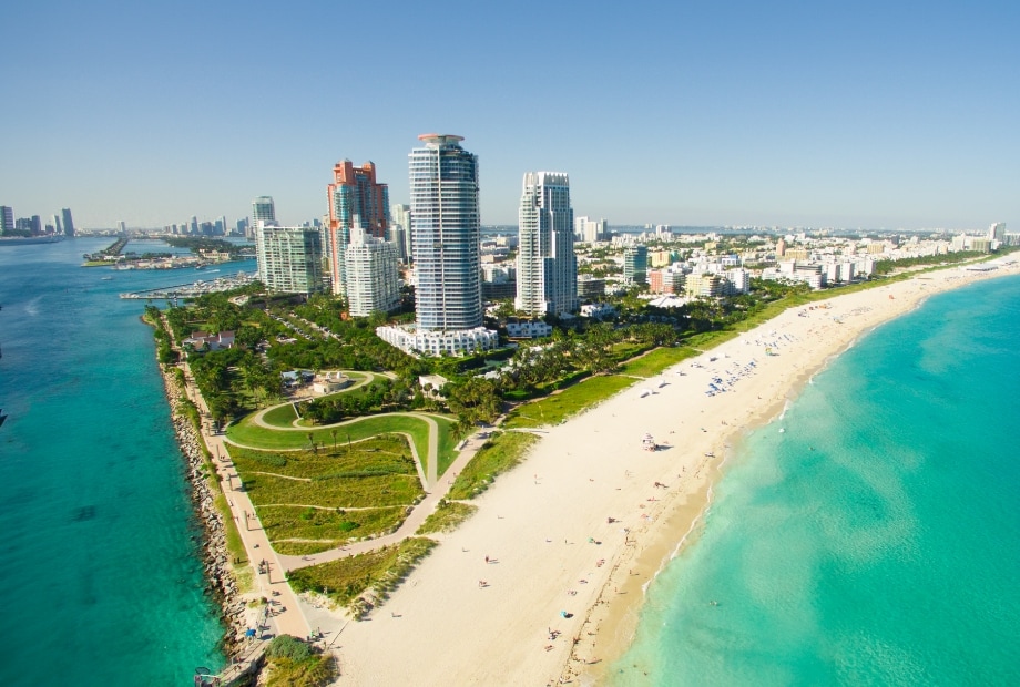 Aerial view of Miami city skyscrapers and the beautiful coast of South Beach.