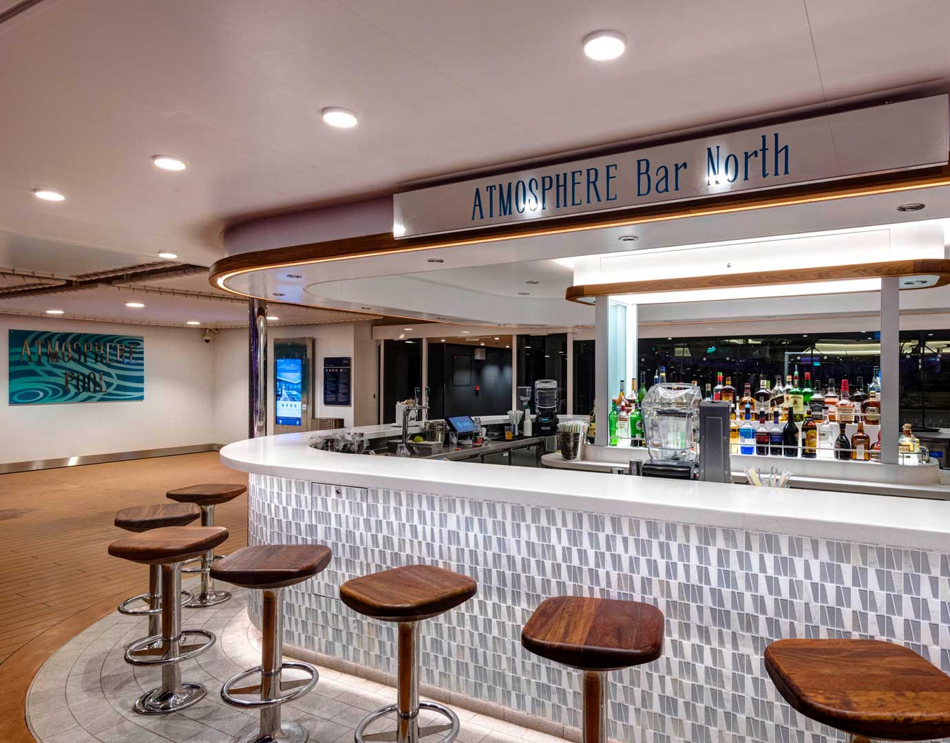 Atmosphere Bar North with wooden stools and a variety of drinks on display | MSC Cruises