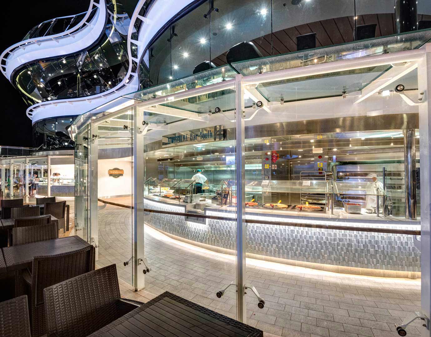 Outdoor buffet dining area on an MSC cruise ship at night with modern architecture and seating | MSC Cruises