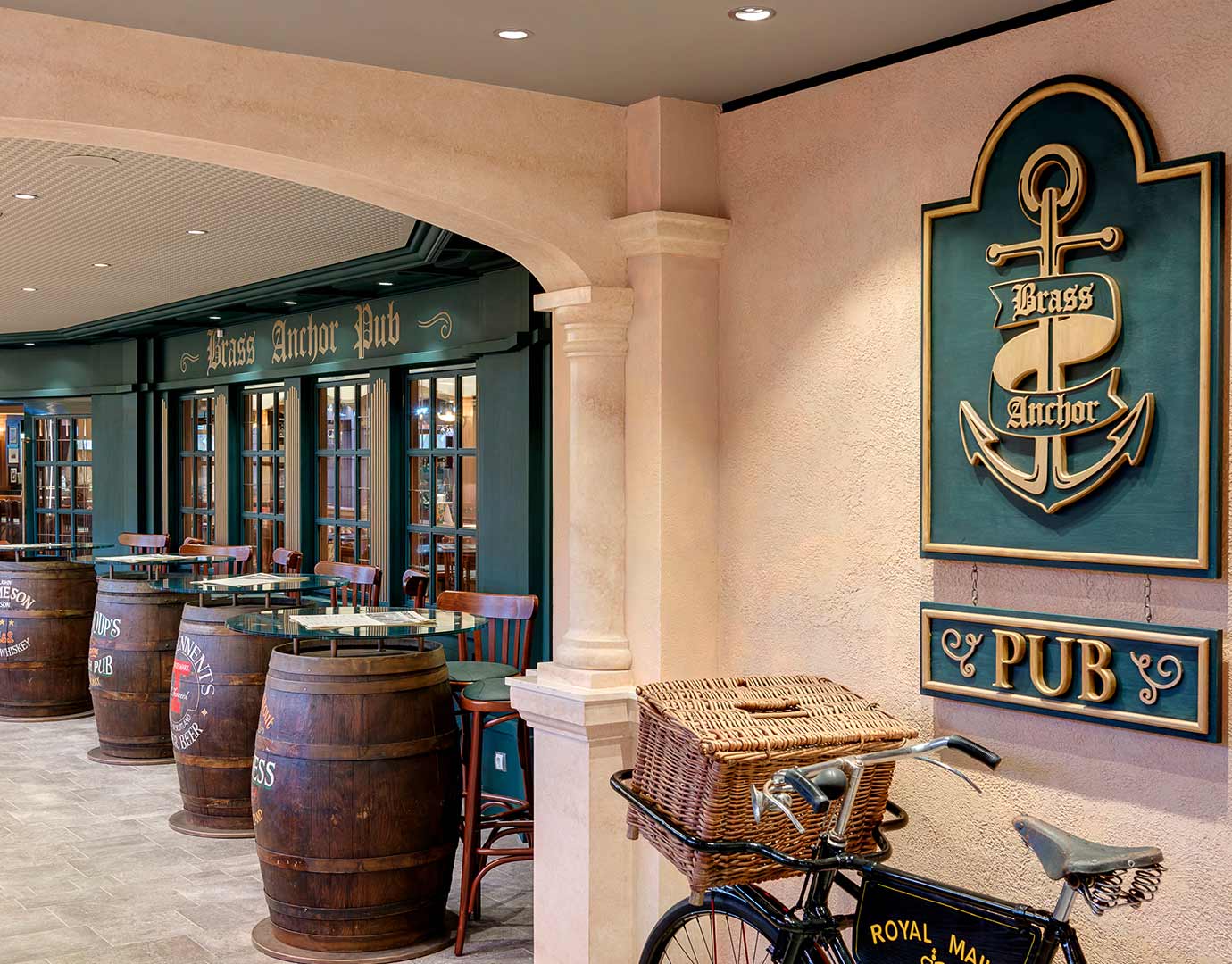The Brass Anchor Pub with barrel tables and a vintage bicycle on an MSC cruise ship | MSC Cruises