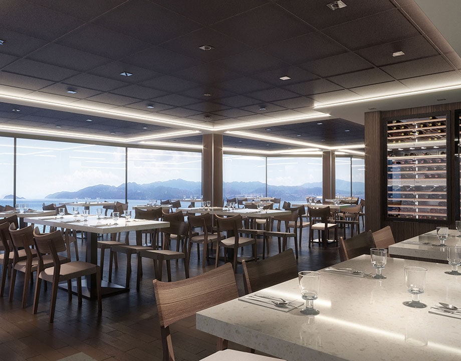 Elegant onboard restaurant with panoramic sea views and a wine display cabinet | MSC Cruises
