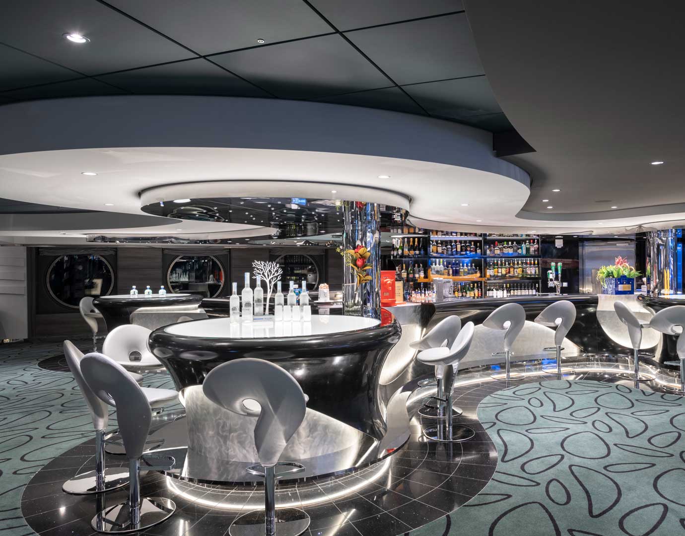 Modern onboard bar with sleek design and illuminated seating area | MSC Cruises