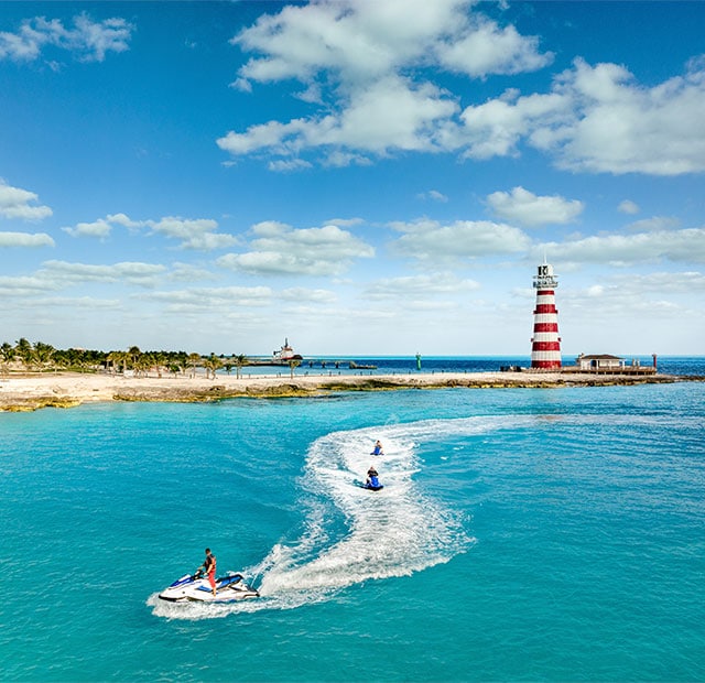 Ride jet skies past the iconic lighthouse and through crystalline waters at Ocean Cay.