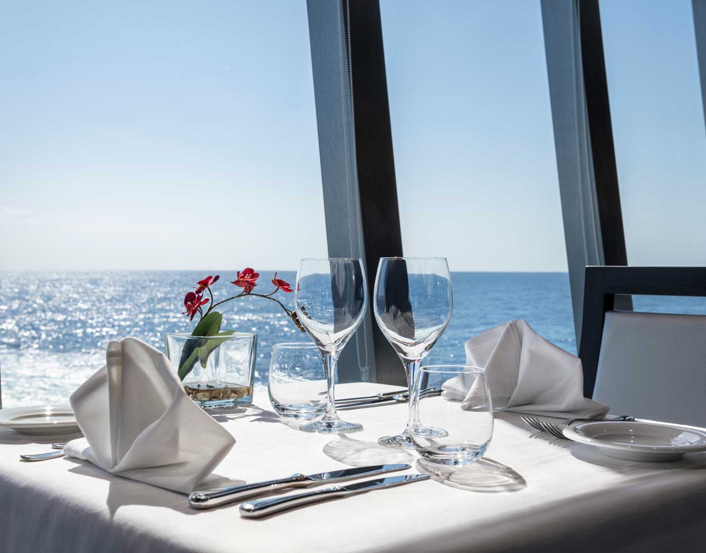 Elegant table setup with ocean view aboard a cruise ship | MSC Cruises