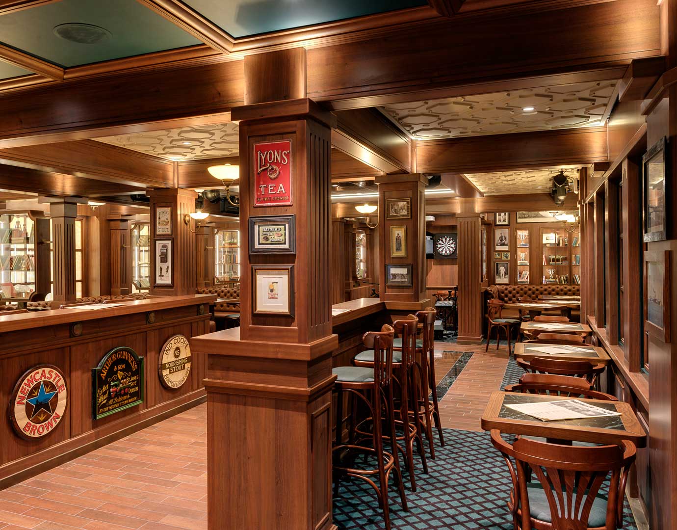 Cozy onboard pub with wooden decor, dartboard, and seating area | MSC Cruises