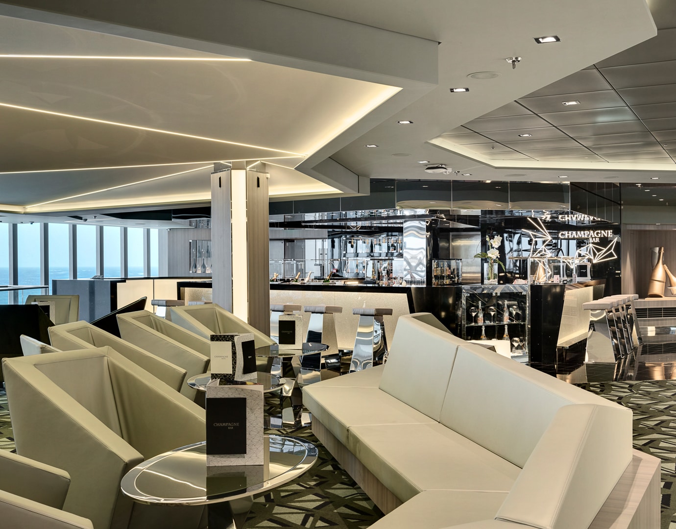 Luxurious champagne bar with modern seating and ocean views onboard | MSC Cruises