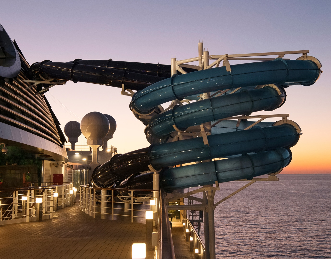 Twisting water slides on an MSC cruise ship at sunset | MSC Cruises