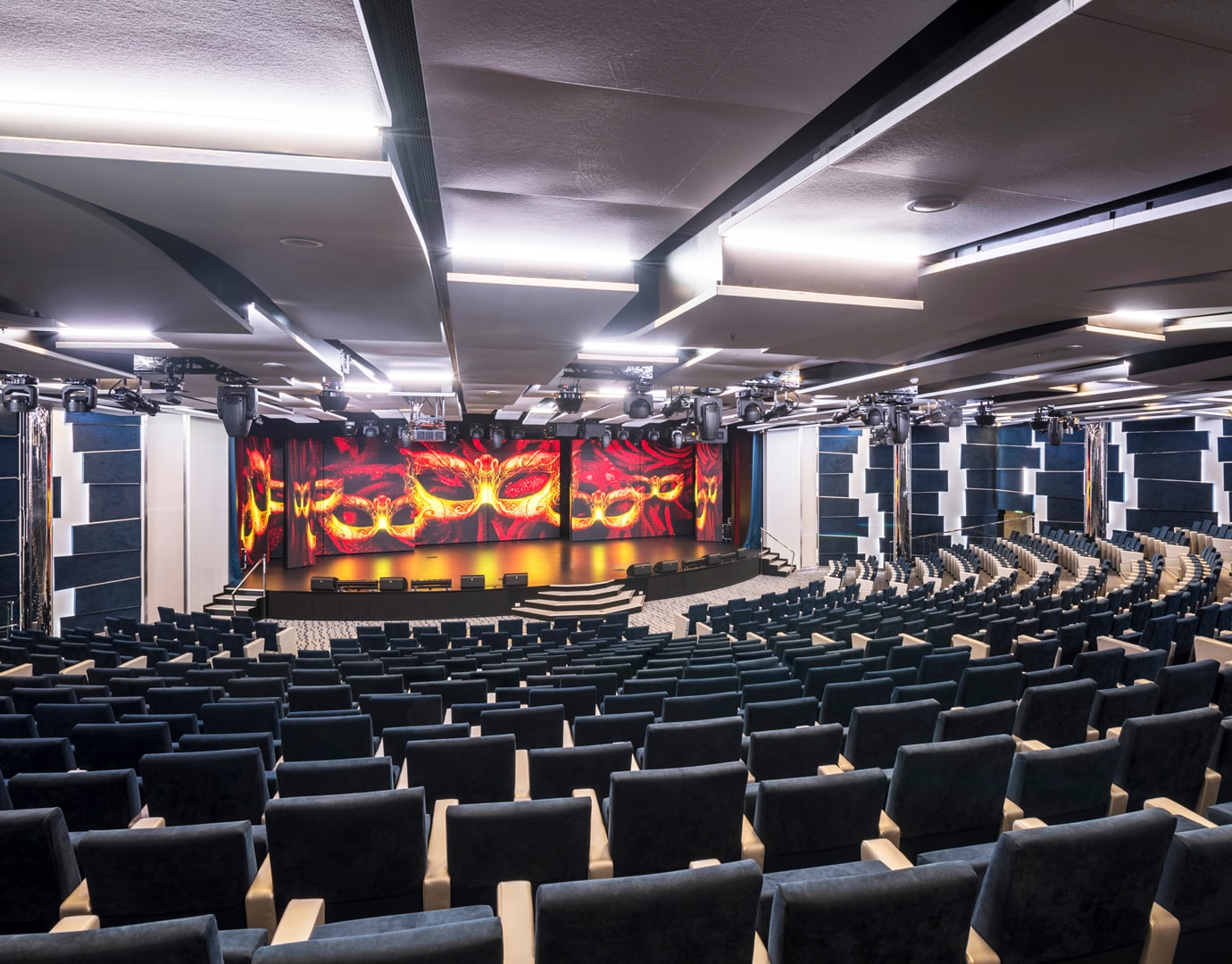 A modern theater with tiered seating and a vibrant stage on an MSC cruise ship | MSC Cruises
