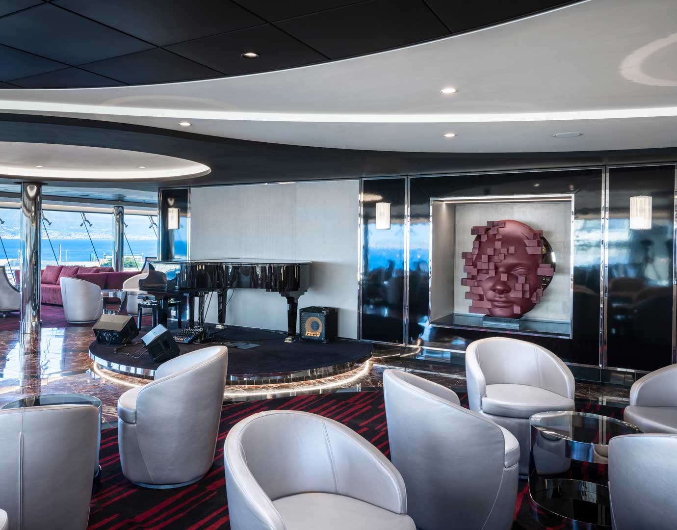 Elegant cruise ship lounge with modern decor, grand piano, and ocean views | MSC Cruises